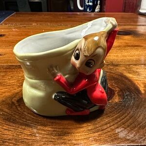 1950 s cricket pixie, dressed in red and black